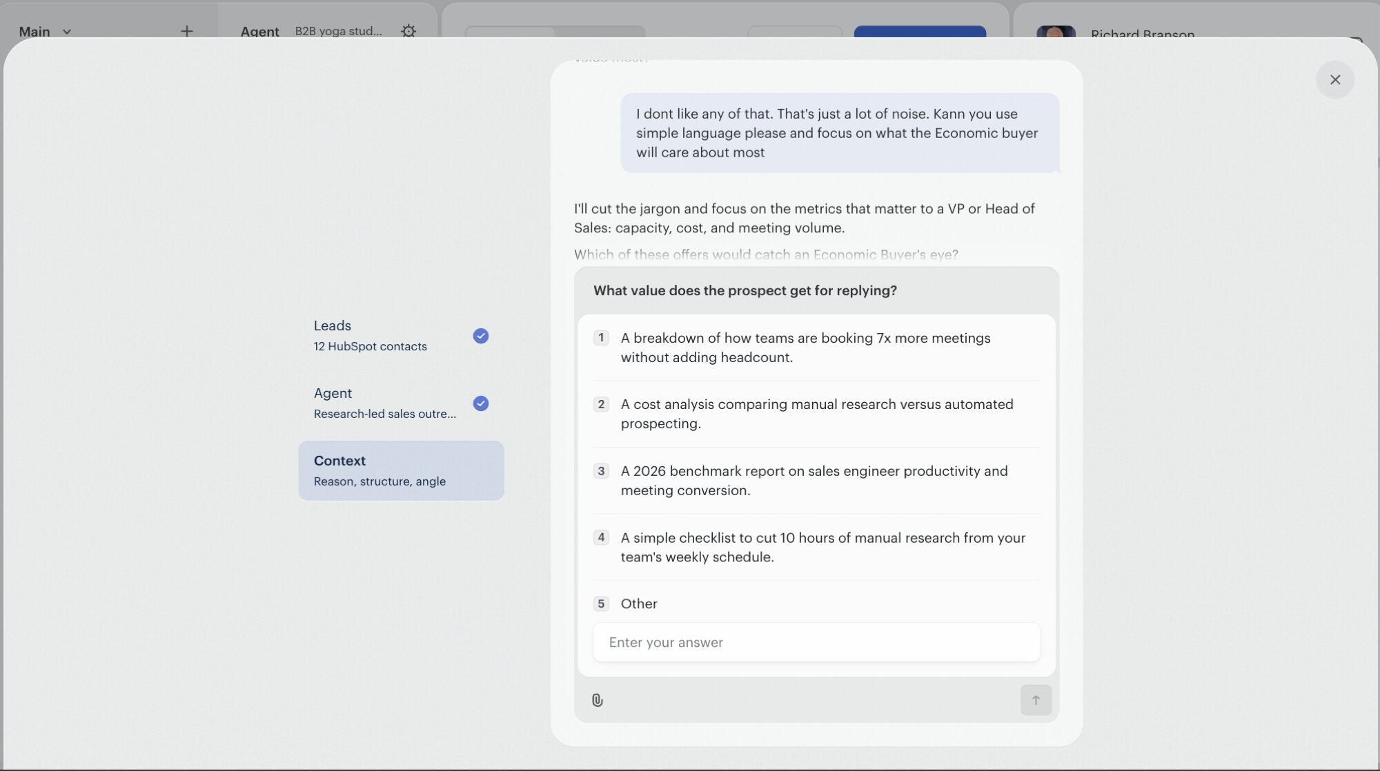 The Campaign Brief chat showing a user push-back. The user typed: 'I dont like any of that. That's just a lot of noise. Kann you use simple language please and focus on what the Economic buyer will care about most'. The assistant replies 'I'll cut the jargon and focus on the metrics that matter to a VP or Head of Sales: capacity, cost, and meeting volume.' and re-proposes a new shortlist of value options: 1) A breakdown of how teams are booking 7x more meetings without adding headcount. 2) A cost analysis comparing manual research versus automated prospecting. 3) A 2026 benchmark report on sales engineer productivity and meeting conversion. 4) A simple checklist to cut 10 hours of manual research from your team's weekly schedule.